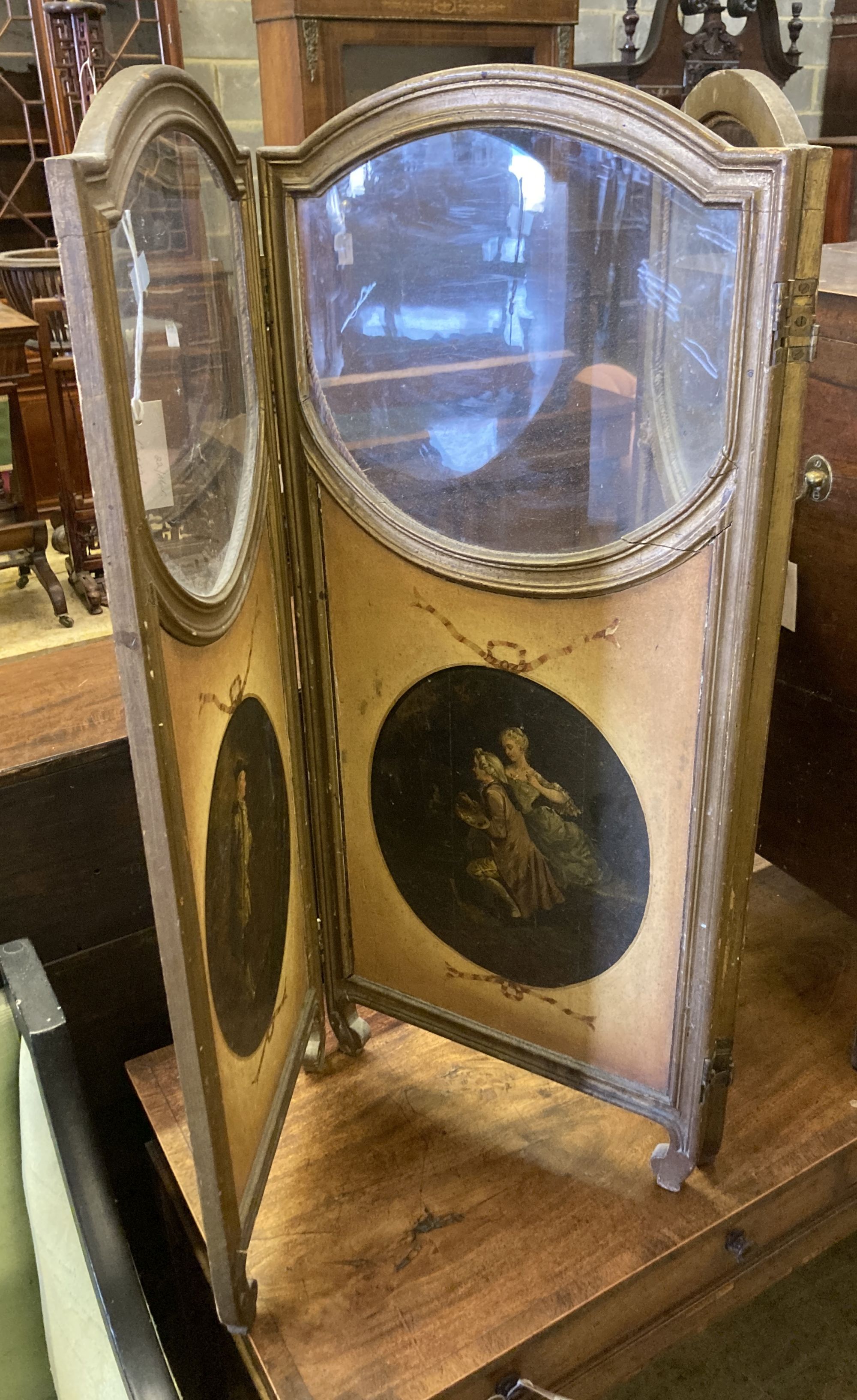 A small late 19th century painted glazed three fold screen, hand painted figures to the face side panels and decorative to the rear pan